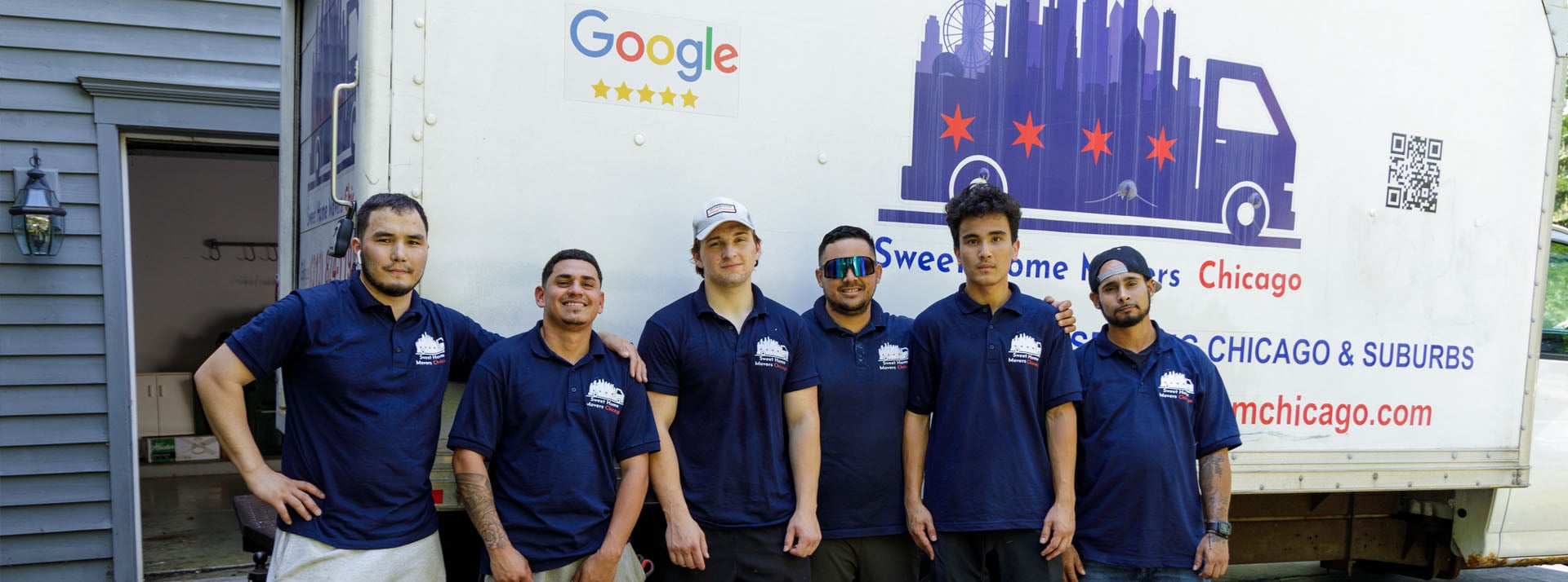 Moving team in front of company truck.