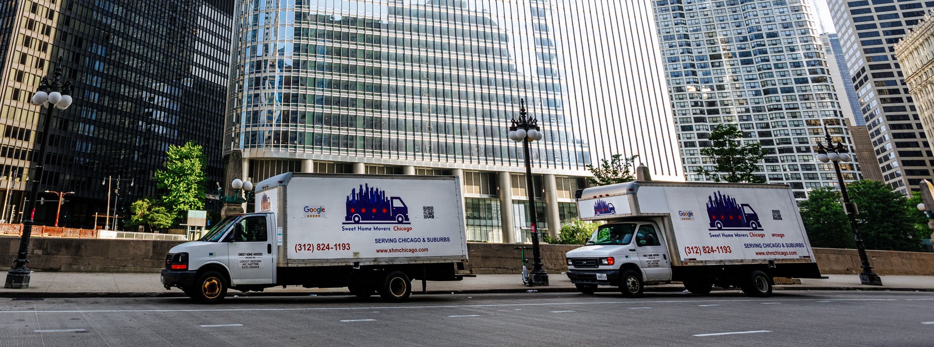 Moving trucks parked near Chicago skyscrapers