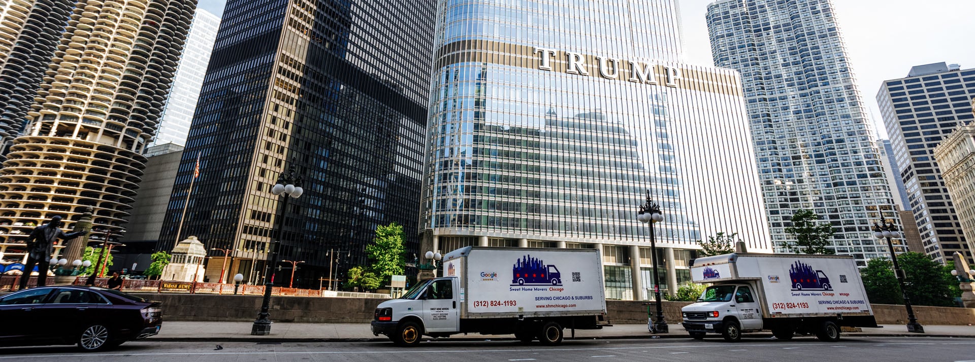 Moving trucks parked near city skyscrapers