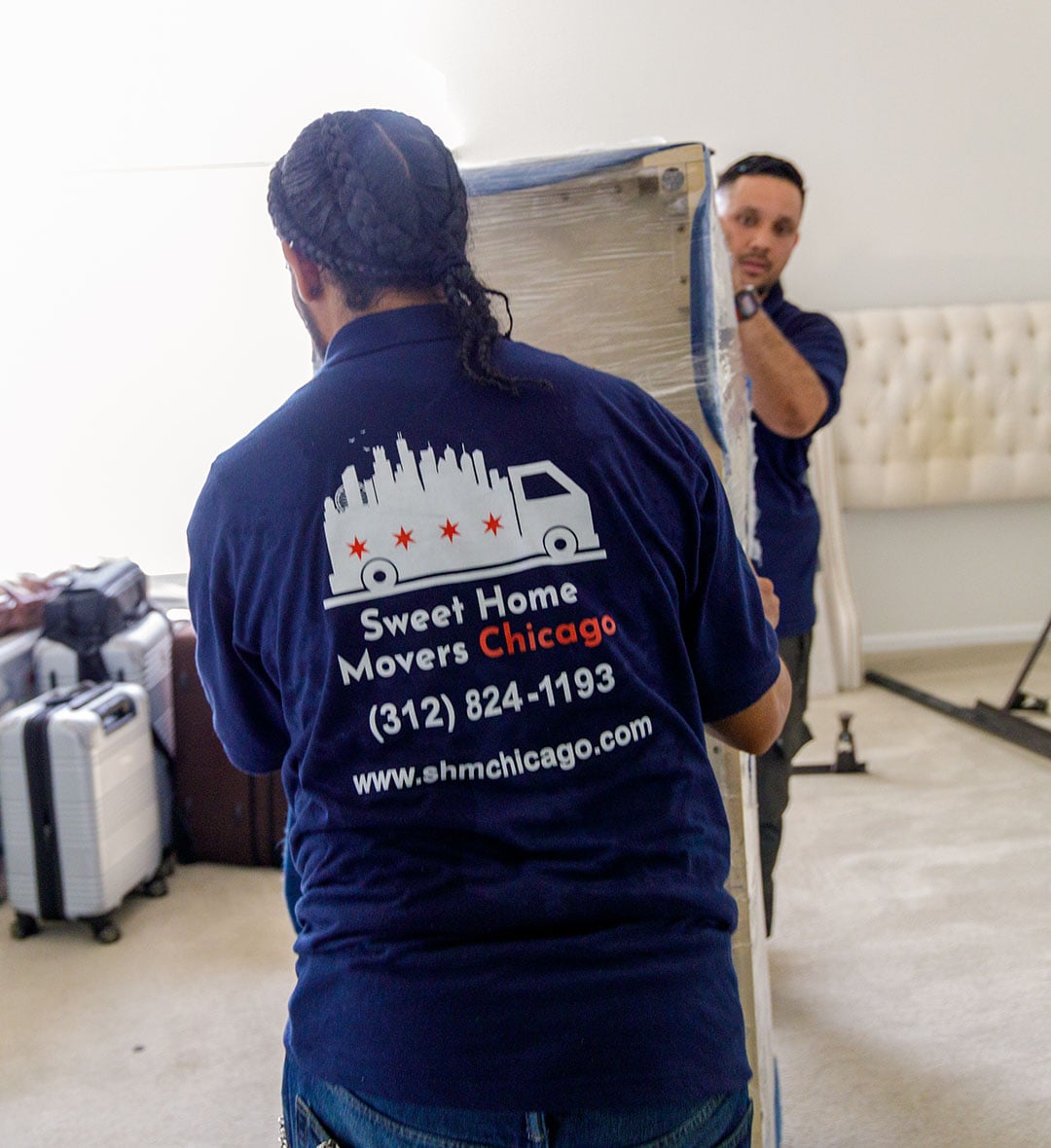 Movers carrying furniture in home for moving service.