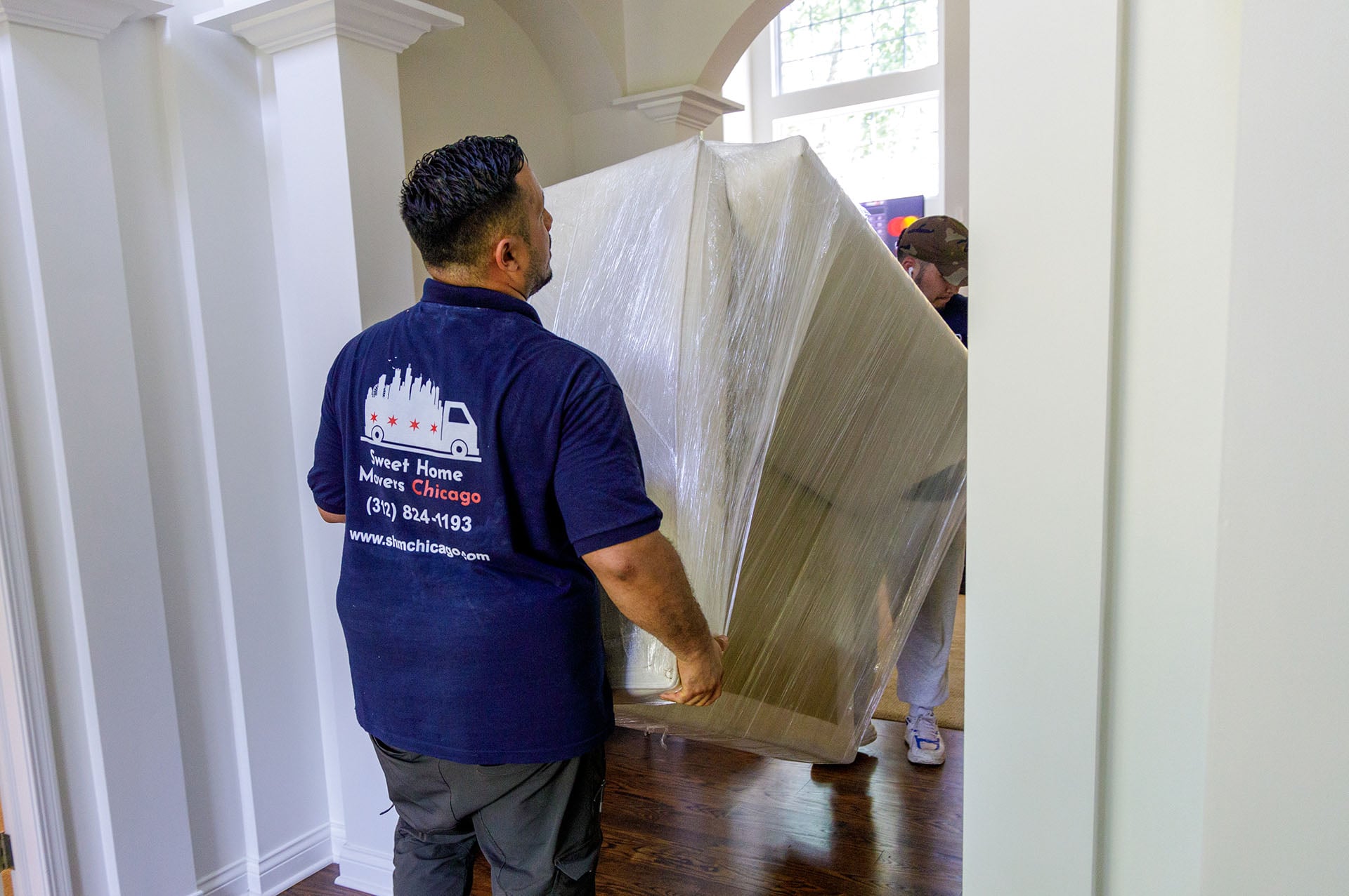 Movers transport furniture in a home