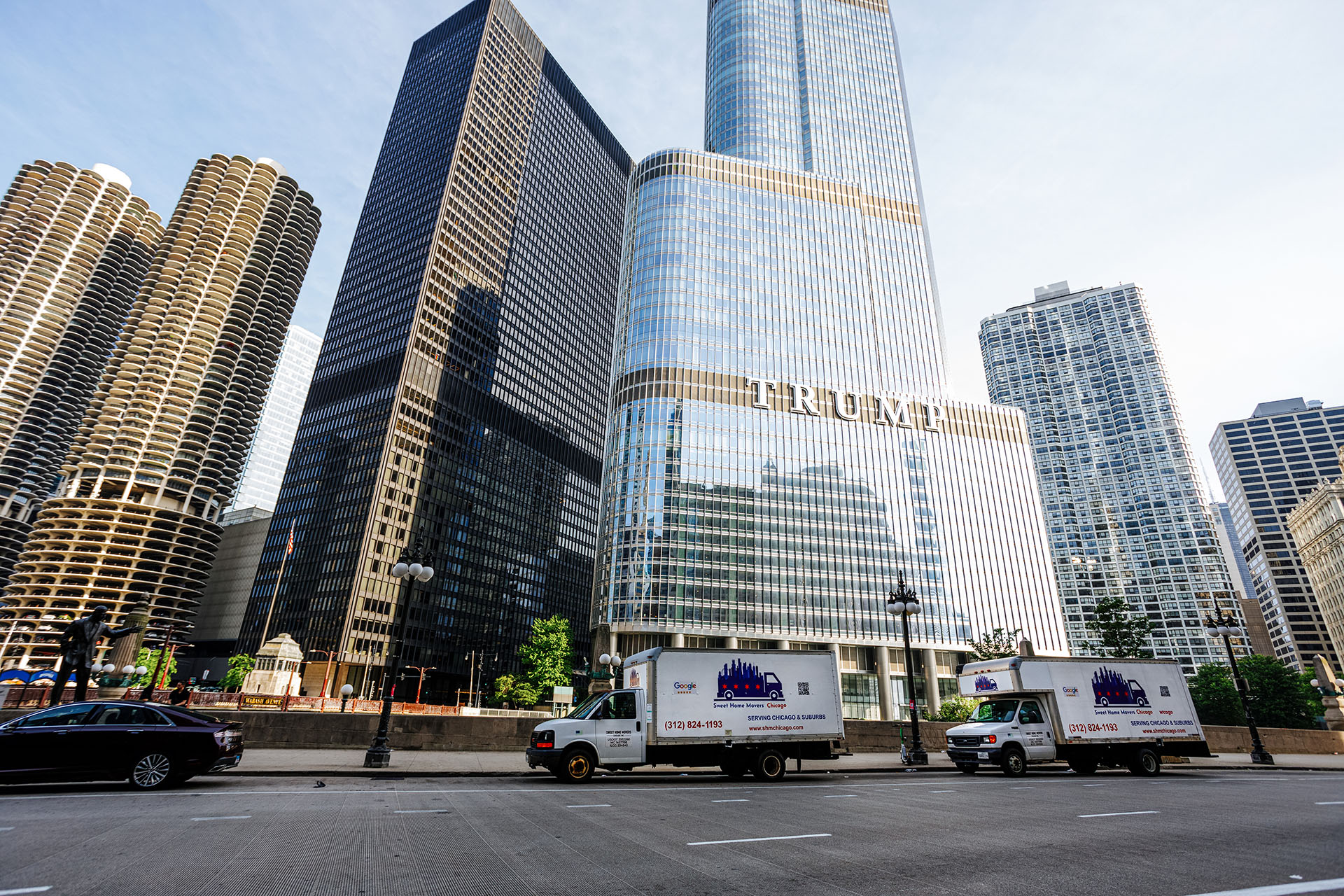 Tall city buildings and moving trucks