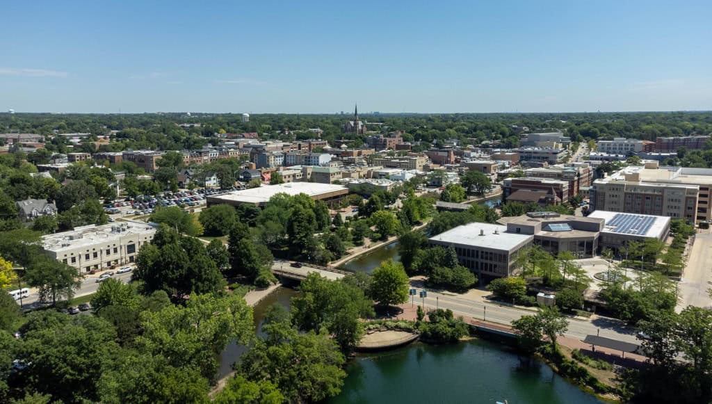 Aerial view of a cityscape with greenery and buildings.